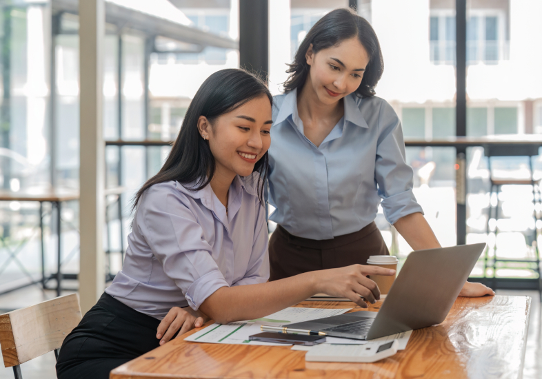 business women looking over laptop